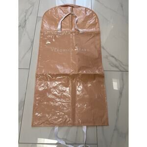 Veronica Beard garment bag made from a shiny, light pink/peach plastic 50”